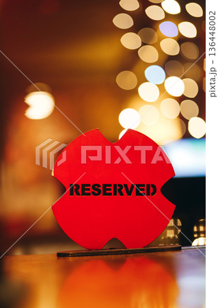 Red Reserved Sign On Wooden Table With Bokeh Background 136448002