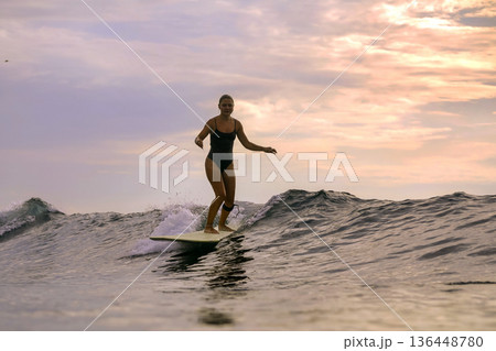 Active Lifestyle Depicted Through Focused Surfing Balance Exercise In Daylight 136448780