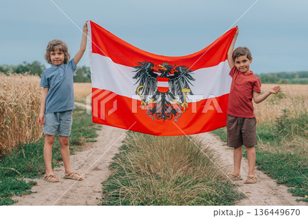 Joyful Kids, Boys Stands In Ripe Wheat Field Holding Austrian Flag, Austria Joyful Kids, Boys Stands In Ripe Wheat Field Holding Austrian Flag, Austria 136449670