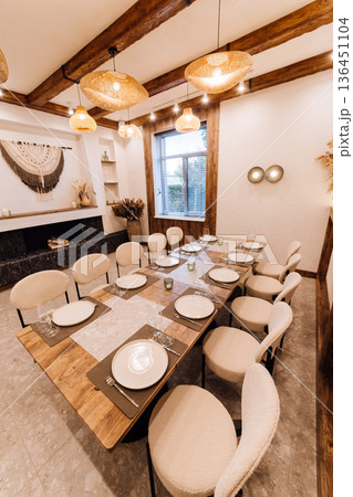 Boho private dining room set for dinner with rattan lamps and pampas wall Boho private dining room set for dinner with rattan lamps and pampas wall 136451104