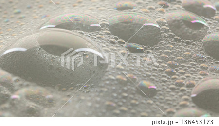 Many bubbles foam from soap bath shampoo shower gel on surface. Fluffy bath foam or beer bubble froth on surface wave curve texture form bubble 136453173