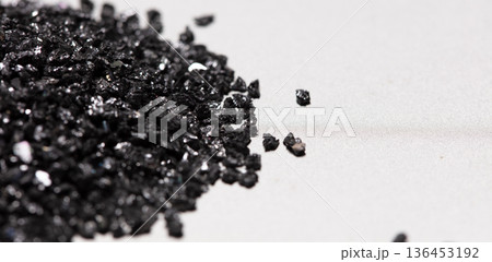 Pile of Silicon Carbide. Black Silicon Carbide crash in small pieces as material based. Fine particle circle around, White background Isolated showing particle element object 136453192