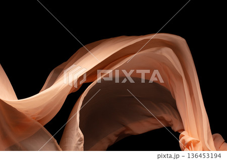 Orange Organza fabric flying in curve shape, Piece of textile Orange Organza fabric throw fall in air. Black background isolated, dark shading environment Orange Organza fabric flying in curve shape, Piece of textile Orange Organza fabric throw fall in air. Black background isolated, dark shading environment 136453194