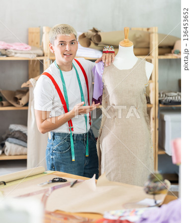 Young male tailor working with mannequin 136453652