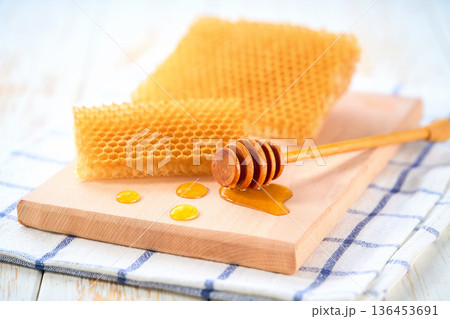 sweet honey with honeycomb on a white table. 136453691