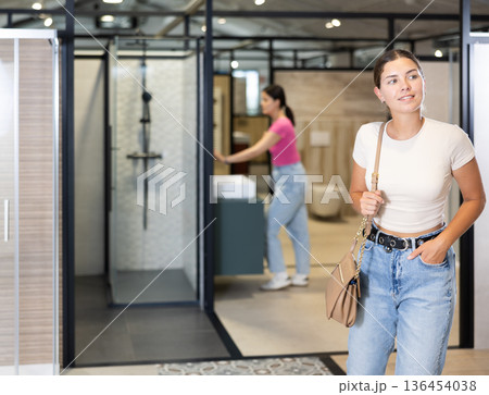 Girl chooses bathroom accessories with interest in hardware store 136454038