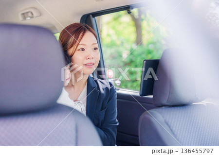 子供と一緒にタクシーに乗る忙しいお母さん 136455797