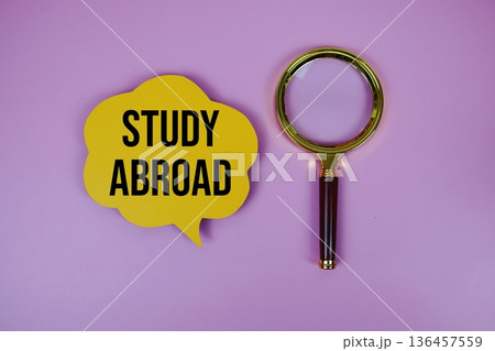 Study Abroad text on speech bubble with magnifying glass on purple background Study Abroad text on speech bubble with magnifying glass on purple background 136457559