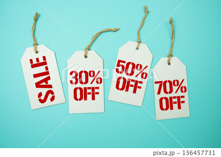 Price tag with "Sale 30%, 50% 70% off" is placed on blue background Price tag with "Sale 30%, 50% 70% off" is placed on blue background 136457731