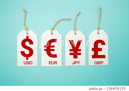 Price tag with "Currency of USD, EUR, JPY, GBP" is placed on blue background 136458135