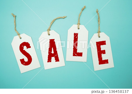 Price tag with "Sale" is placed on blue background 136458137