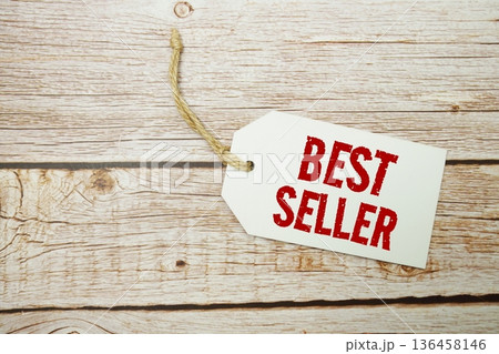 Price tag with "Best Seller" is placed on wooden background Price tag with "Best Seller" is placed on wooden background 136458146