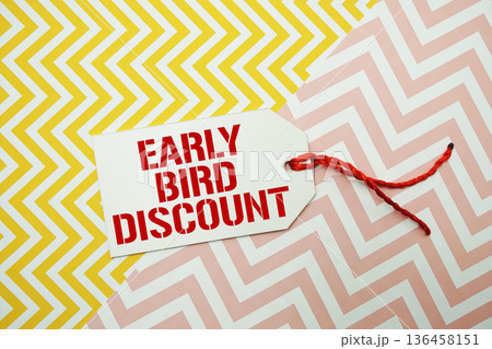 Price tag with "Early Bird Discount" is placed on a colorful zigzag patterned background Price tag with "Early Bird Discount" is placed on a colorful zigzag patterned background 136458151
