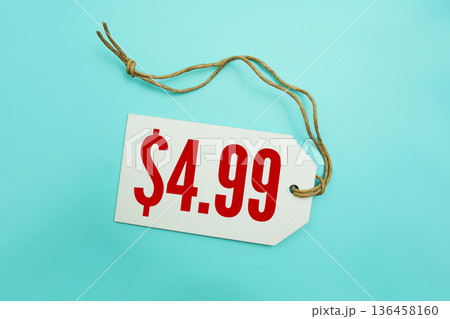 Price tag with "$4.99" is placed on blue background 136458160