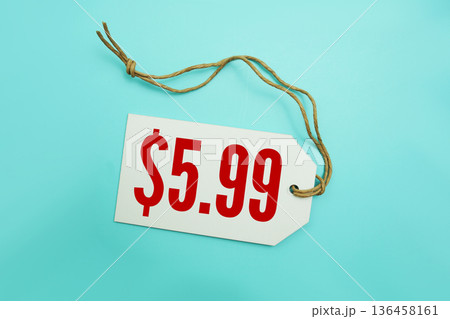 Price tag with "$5.99" is placed on blue background 136458161