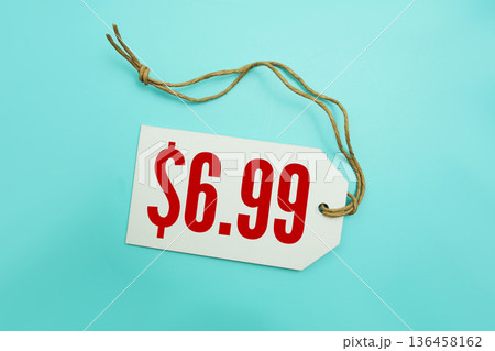 Price tag with "$6.99" is placed on blue background 136458162