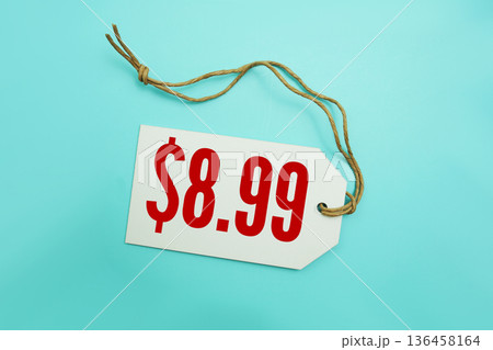 Price tag with "$8.99" is placed on blue background 136458164