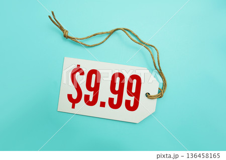 Price tag with "$9.99" is placed on blue background Price tag with "$9.99" is placed on blue background 136458165