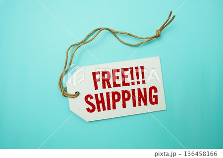 Price tag with "Free Shipping" is placed on blue background 136458166