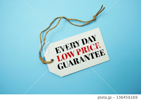 Price tag with "Every Day Low Price Guarantee" is placed on blue background 136458169