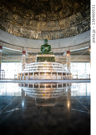 The largest jade Buddha statue in the world is enshrined under the bronze dome with craving historic panels at Wat Dhamma Mongkol temple, Bangkok, Thailand. 136460531