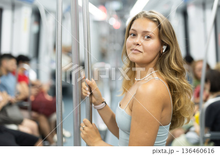 Positive young girl standing in wagon with wireless headphones on airs 136460616