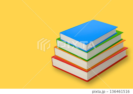 Stack of blank books in different colors on a yellow background Stack of blank books in different colors on a yellow background 136461516