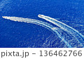 Thrilling boat race across the vibrant blue ocean waves on a sunny day 136462766