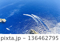 Boats gliding gracefully over vibrant blue waters near stunning rocky coastlines at midday 136462795