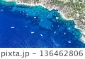 Breathtaking turquoise waters adorned with boats in a serene coastal cove during a sunny day in summer 136462806