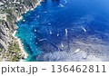 Breathtaking view of boats gliding over emerald waters in the stunning coastline of Capri on a sunlit afternoon 136462811