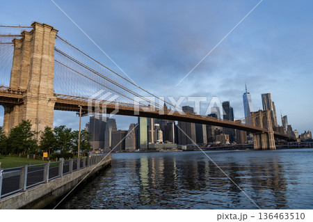 Brooklyn bridge to Manhattan. Urban architecture of New York city. Brooklyn bridge of New York city. Brooklyn landmark. Manhattan cityscape with skyscraper architecture. Hudsson river Brooklyn bridge to Manhattan. Urban architecture of New York city. Brooklyn bridge of New York city. Brooklyn landmark. Manhattan cityscape with skyscraper architecture. Hudsson river 136463510