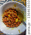 Authentic Indian Black Chickpea Curry (Kala Chana) in a White Scalloped Bowl on a Traditional Woven Mat. 136463650
