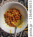 Spiced Chickpea Curry in a White Bowl on a Traditional Woven Mat 136463653
