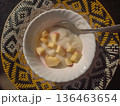 White Porridge Bowl Topped with Fresh Apple Chunks on Woven Mat 136463654