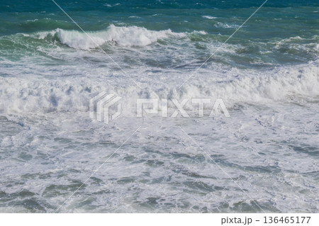Natural marine background of stormy sea surface, powerful waves and white foam. Natural marine background of stormy sea surface, powerful waves and white foam. 136465177
