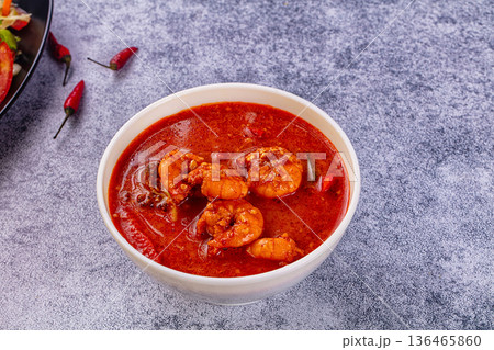 Spicy shrimp soup Red Thai Curry with prawns and vegetables in a vibrant red broth. Asian cuisine concept. Spicy shrimp soup Red Thai Curry with prawns and vegetables in a vibrant red broth. Asian cuisine concept. 136465860