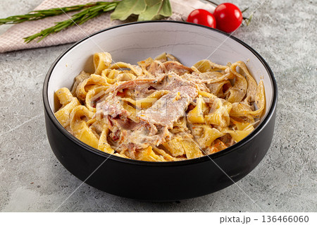 Italian pasta fettuccine with prosciutto Italian pasta fettuccine with prosciutto 136466060