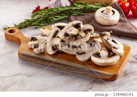 Raw champignon slices on the board Raw champignon slices on the board 136466141