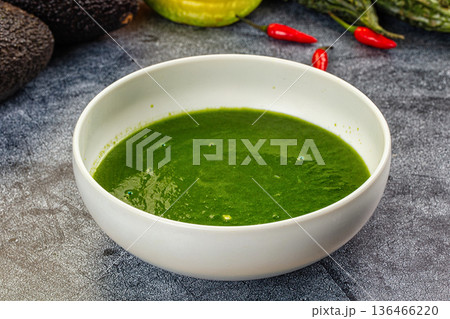 Green Spinach vegetable soup in a bowl with fresh avocado and chili peppers Green Spinach vegetable soup in a bowl with fresh avocado and chili peppers 136466220