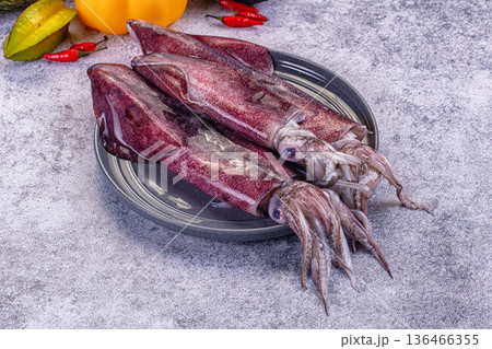 Fresh raw squid on a plate with exotic vegetables for cooking Fresh raw squid on a plate with exotic vegetables for cooking 136466355