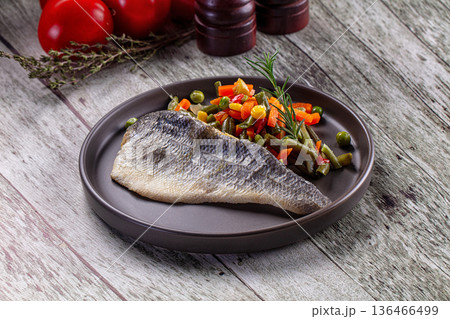 Steamed seabass fish fillet with vegetables 136466499