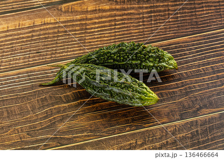 Whole bitter gourds on a dark textured slate background with copy space Whole bitter gourds on a dark textured slate background with copy space 136466664