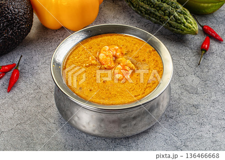 Authentic shrimp curry in a bowl with fresh chili, pepper, and avocado ingredients. 136466668