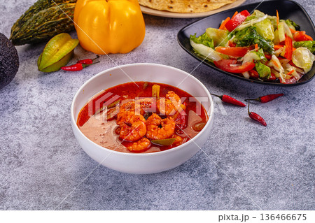 Spicy shrimp soup Red Thai Curry with prawns and vegetables in a vibrant red broth. Asian cuisine concept. Spicy shrimp soup Red Thai Curry with prawns and vegetables in a vibrant red broth. Asian cuisine concept. 136466675