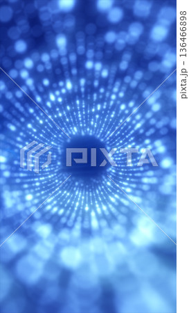Blue glowing dot tunnel forming a radial vortex with depth and motion blur, abstract futuristic background for data flow and sci-fi technology 136466898