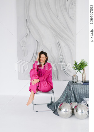 Elegant Woman In Pink Outfit Sitting On Chair Elegant Woman In Pink Outfit Sitting On Chair 136467092