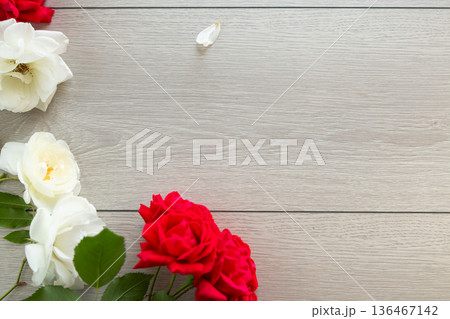 Light wooden background with white and red roses Light wooden background with white and red roses 136467142