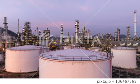 Aerial view oil and gas petrochemical storage tank with oil and gas refinery plant at twilight, Global business power and energy petrochemical industry, Oil and gas refinery petrochemical industrial. 136467565
