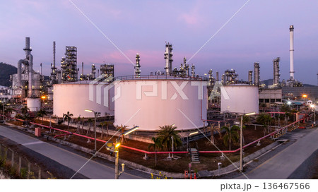 Aerial view oil and gas petrochemical storage tank with oil and gas refinery plant at twilight, Global business power and energy petrochemical industry, Oil and gas refinery petrochemical industrial. 136467566